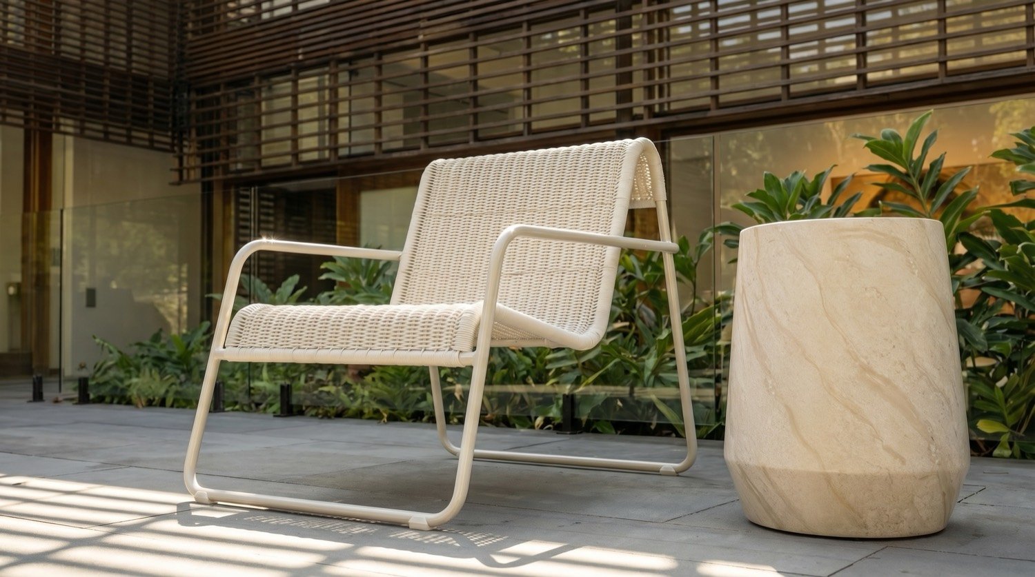 Woven chair and stone side table in a courtyard